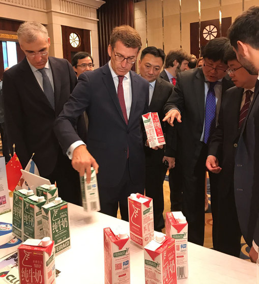 El conselleiro de Economía y el presidente de la Xunta enseñan envases de leche gallega a los invitados chinos del Galician Gourmet Extravaganza.